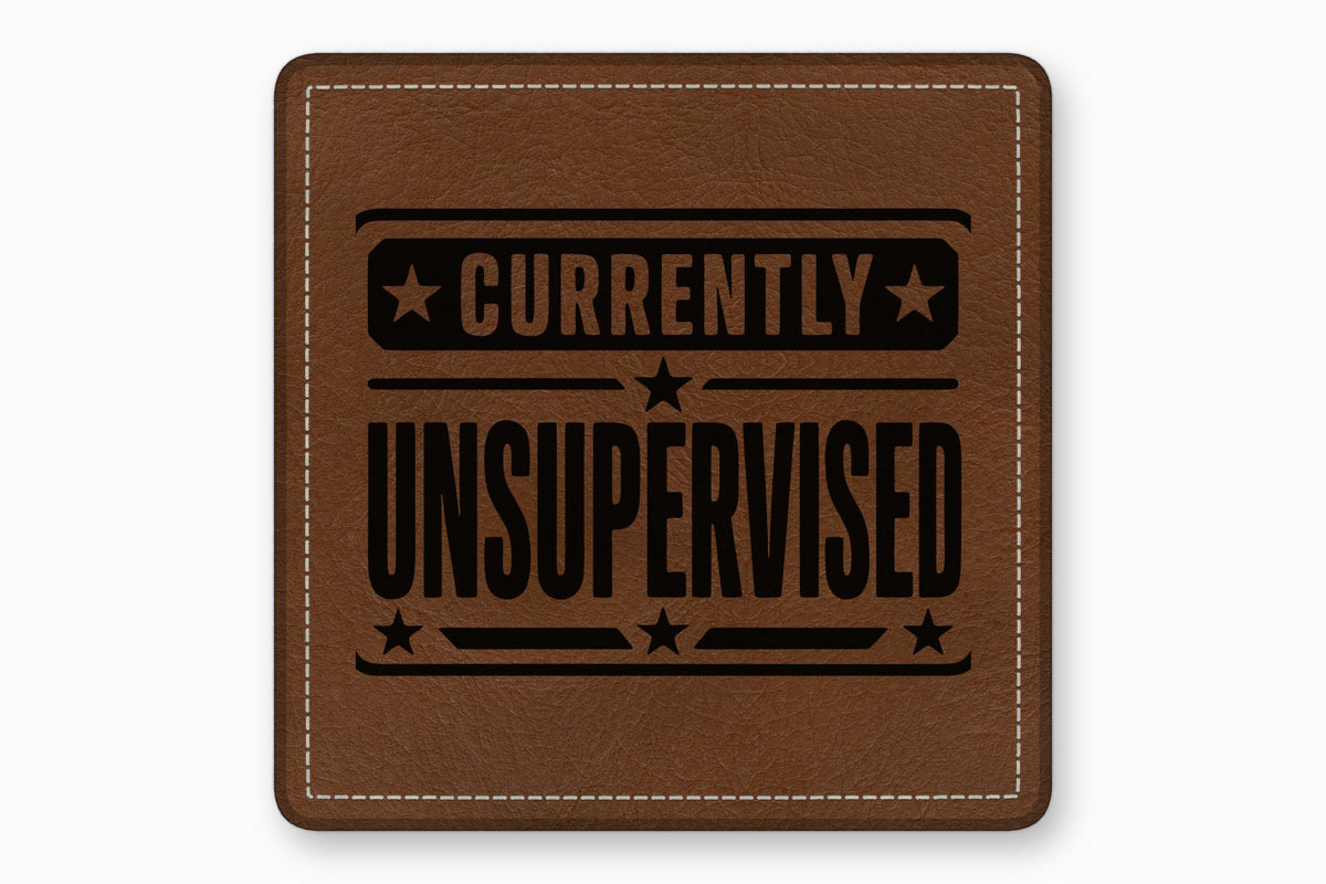 Brown leather patch with white stitched border and black text reading Currently Unsupervised.