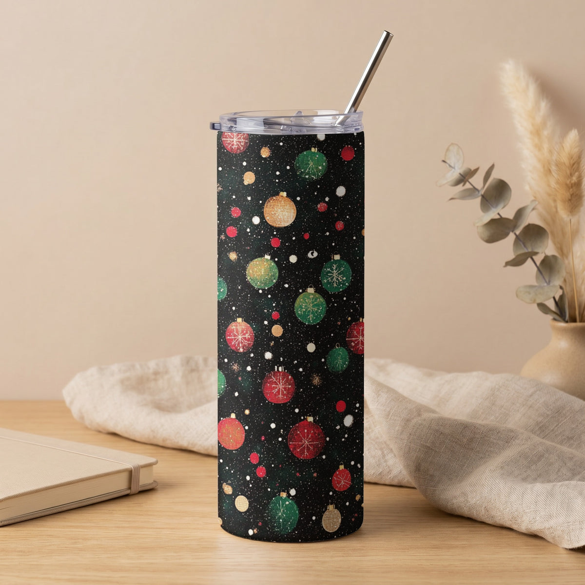Tall tumbler with a black background and festive red, green, and gold Christmas ornament pattern.