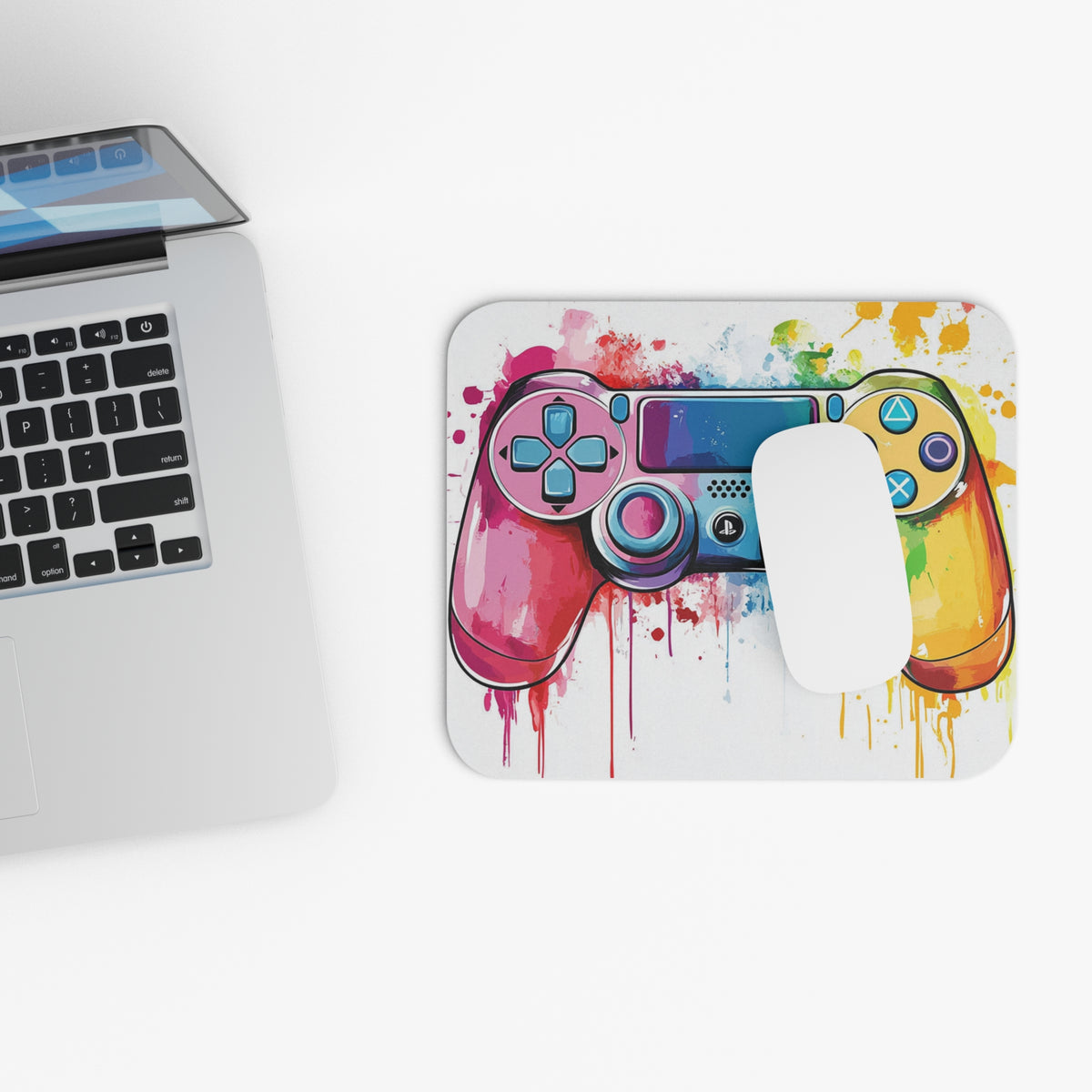 Mousepad with colorful watercolor gamepad design and white mouse.