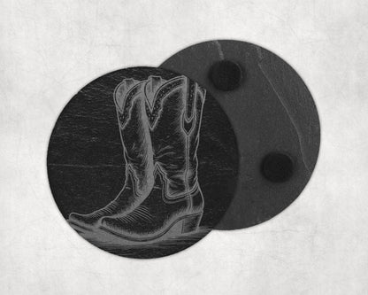 Engraved cowboy boot design on a round, dark slate coaster with two felt pads.