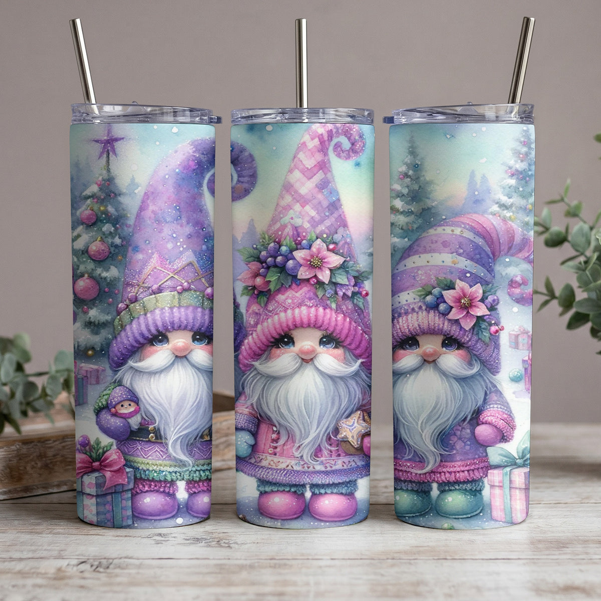 Three tumblers with pastel watercolor gnomes, Christmas trees, and gifts.