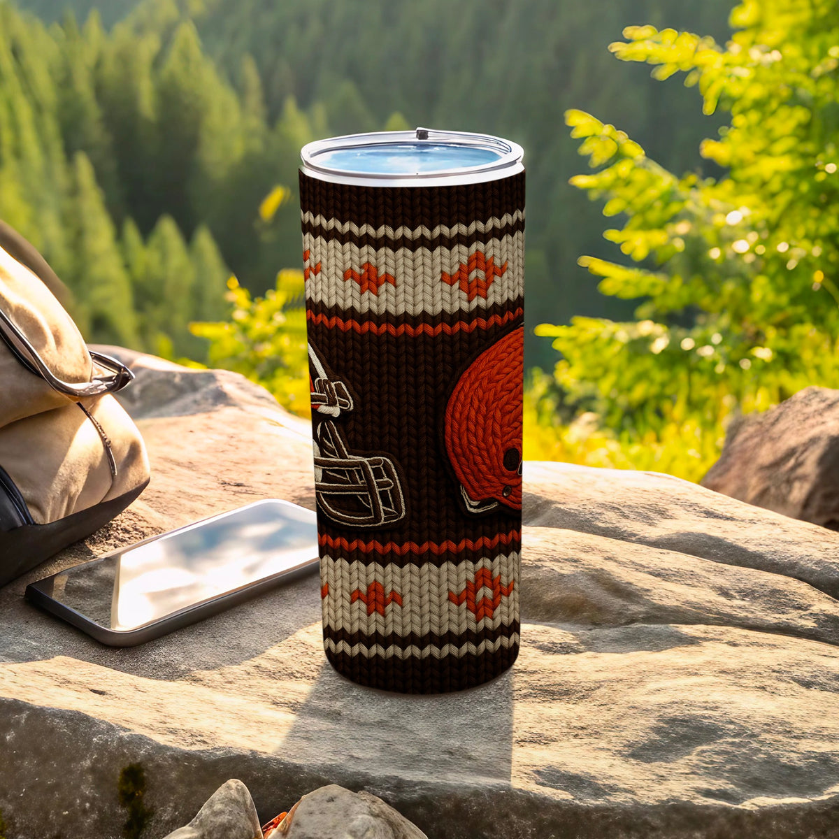 Tumbler with knit pattern, football helmet, and football design on rocks.