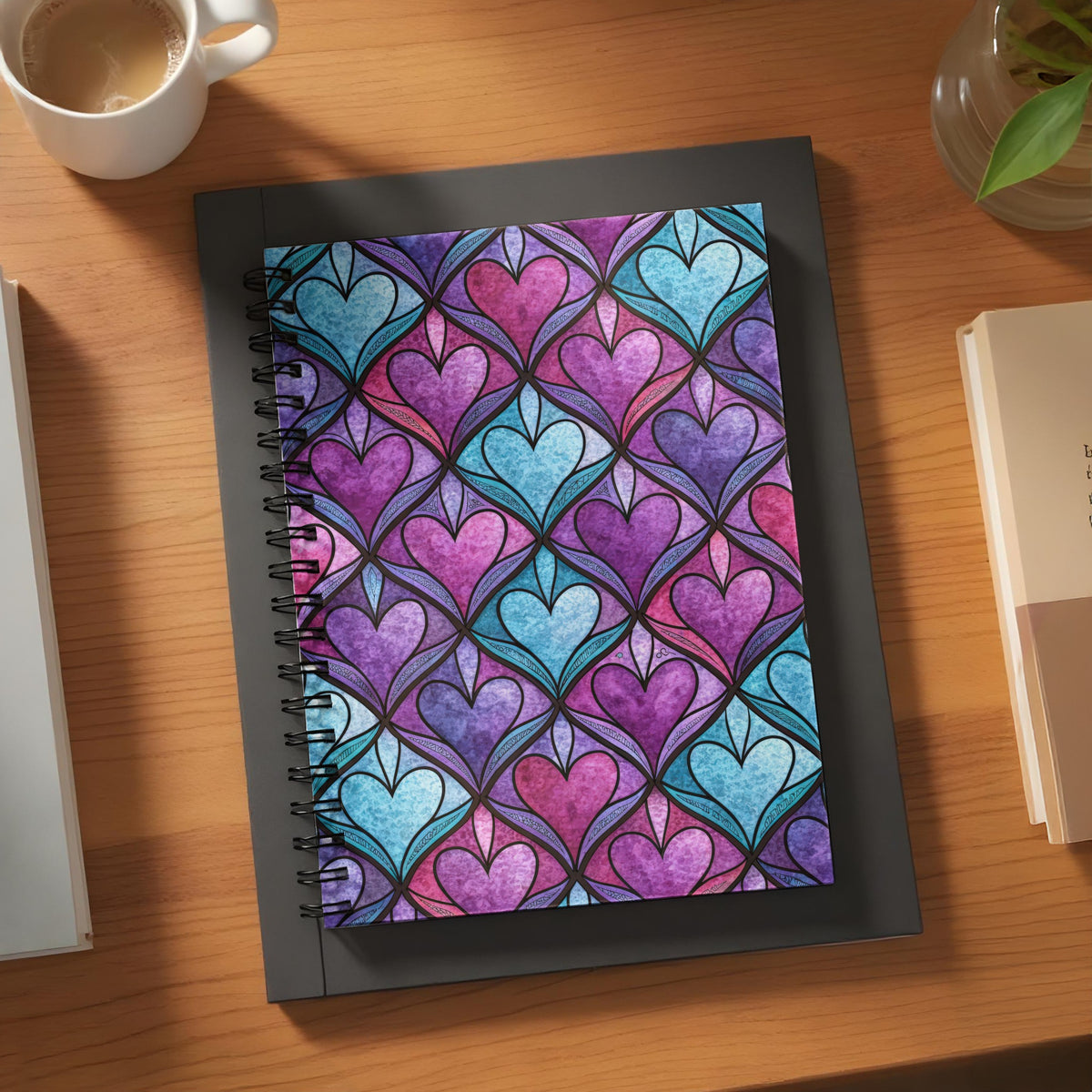 Spiral notebook with a stained-glass heart pattern in purple and blue.