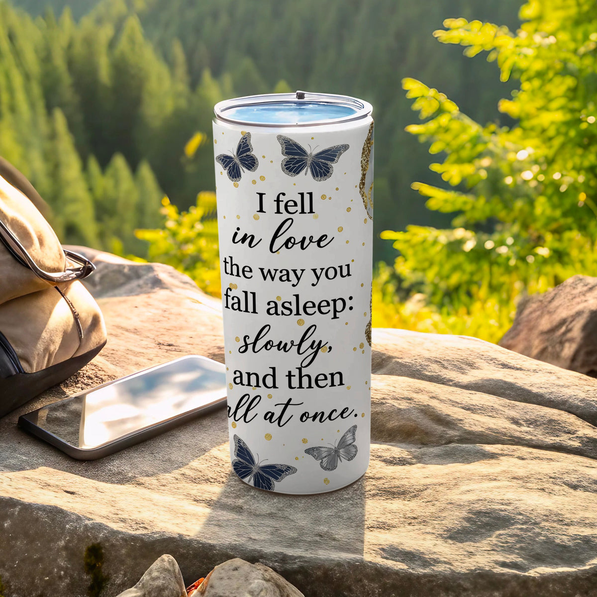 White tumbler with butterflies and text "I fell in love the way you fall asleep: slowly, and then all at once."
