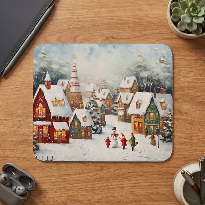 Watercolor mousepad featuring a snowy village scene with a snowman and people.