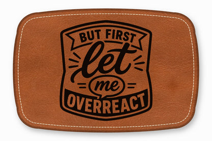 Brown leather patch with white stitching and black text reading But first let me overreact.