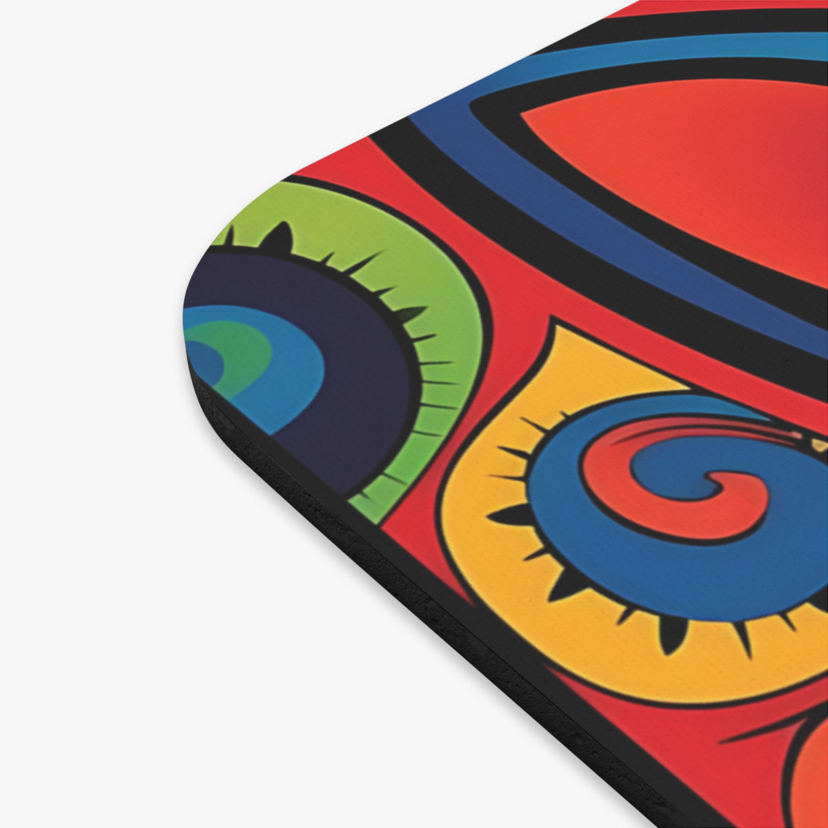 Mousepad corner showing a vibrant, colorful abstract design with concentric shapes in red, blue, green, and yellow.