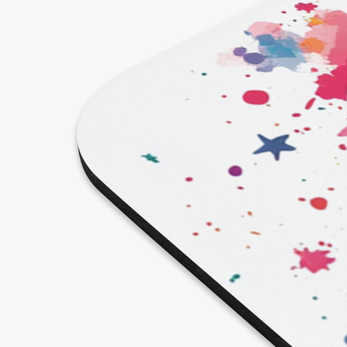 White mousepad with colorful paint splatters and blue stars pattern.