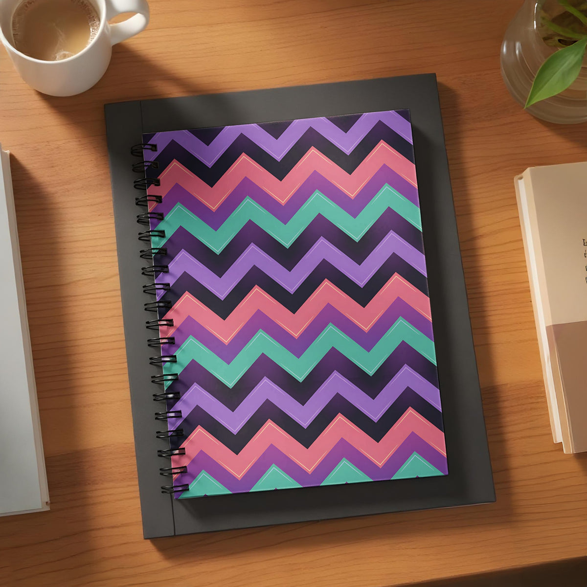 Spiral notebook with purple, pink, teal, and black chevron pattern.