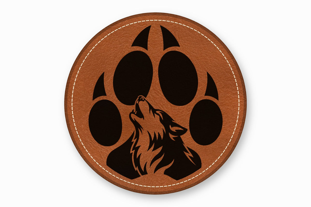 A round brown leather patch features a black wolf howling inside a paw print design.