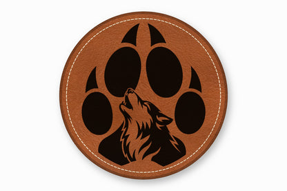 A round brown leather patch features a black wolf howling inside a paw print design.