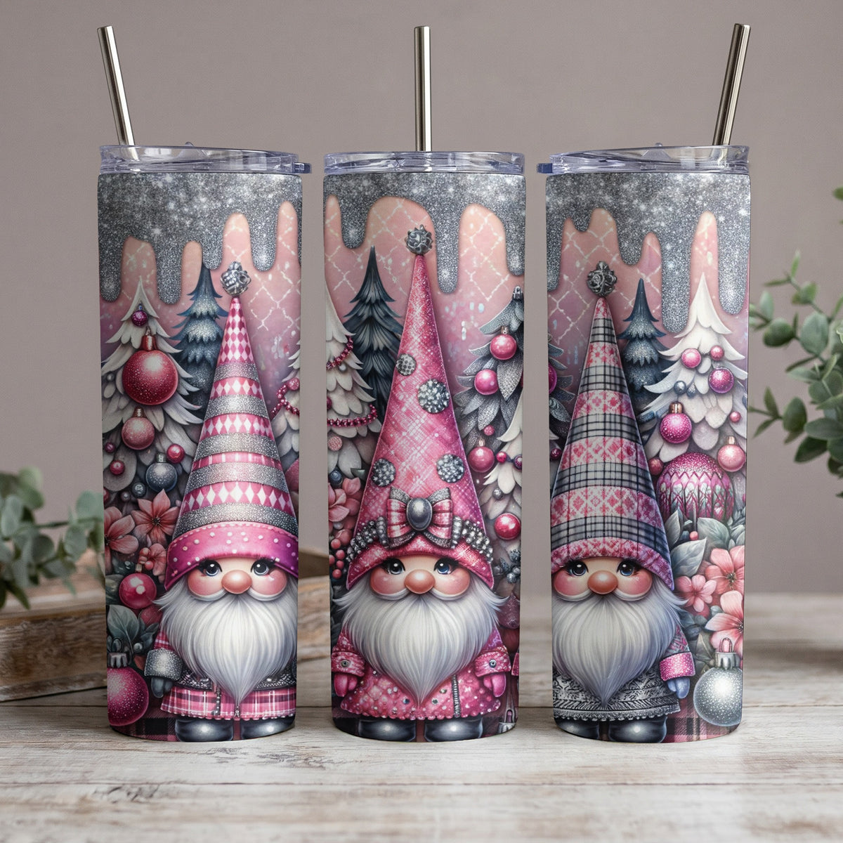 Three pink Christmas gnomes with festive trees and ornaments on tumblers.