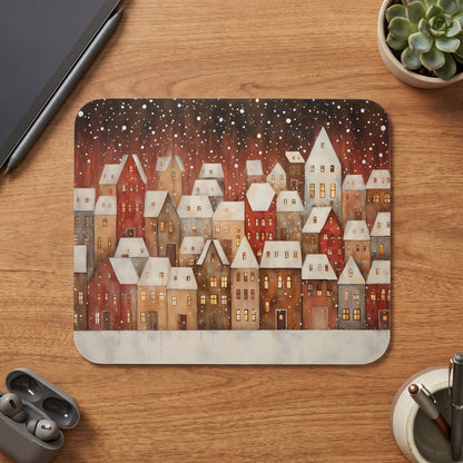 Watercolor illustration of snow-covered buildings with lit windows and falling snow.
