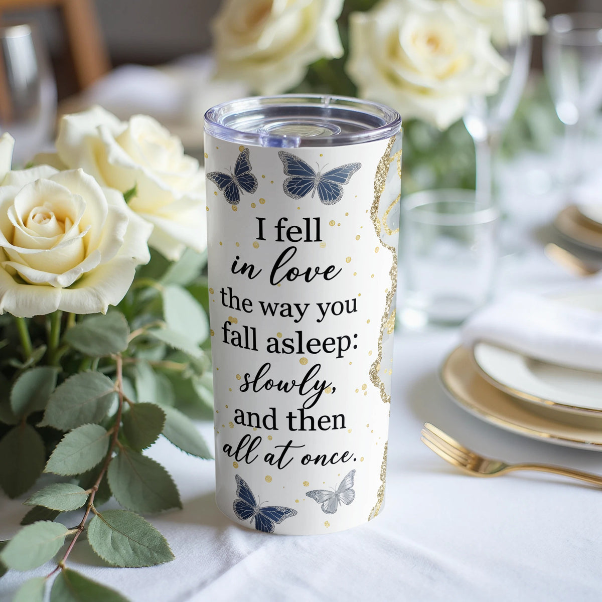 White tumbler with butterflies and quote "I fell in love the way you fall asleep: slowly, and then all at once."