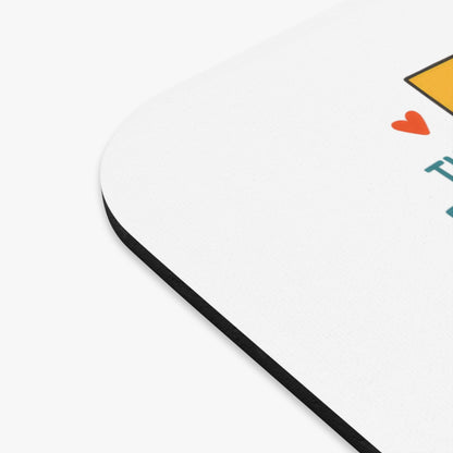 Mousepad with orange heart and teal text on white background.