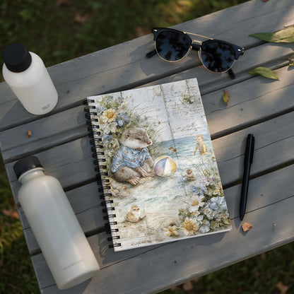 Notebook with a watercolor illustration of an otter and baby birds by the sea.