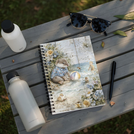 Notebook with a watercolor illustration of an otter and baby birds by the sea.