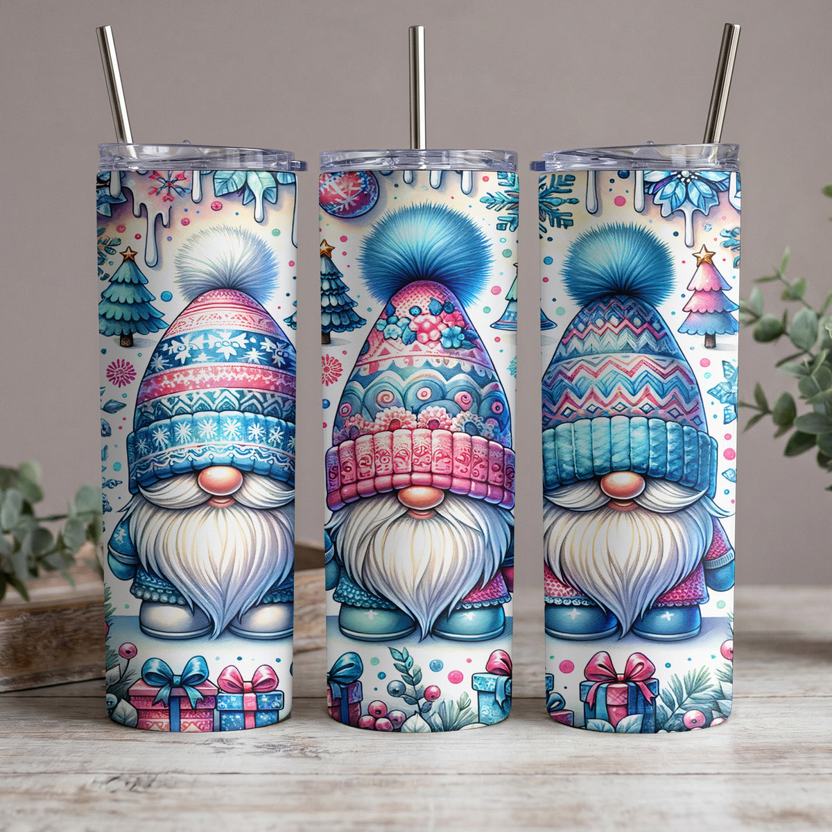 Three tumblers featuring watercolor gnomes with festive winter hats and holiday decorations.