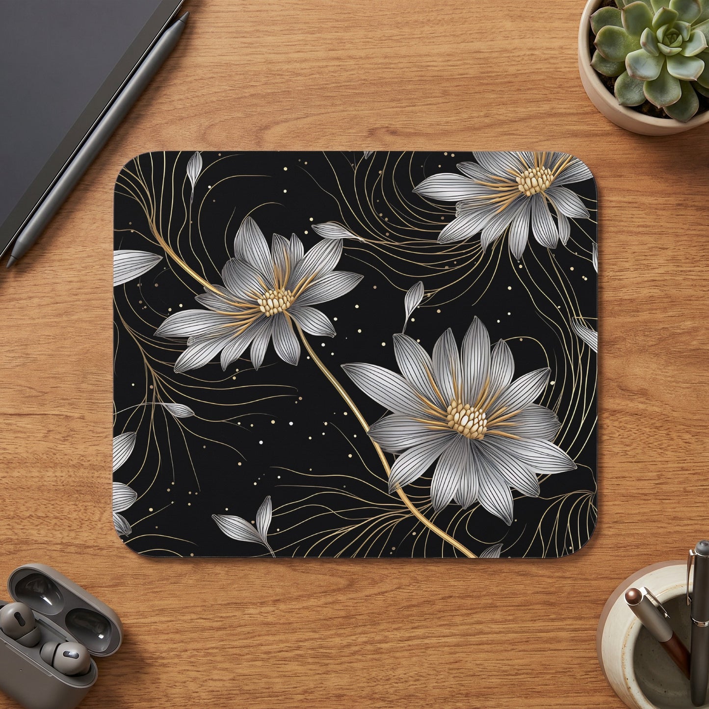 Black mousepad with silver and gold floral line art and scattered dots.