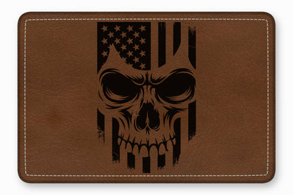 Brown leather patch with rounded corners featuring a black engraved distressed skull and American flag design.
