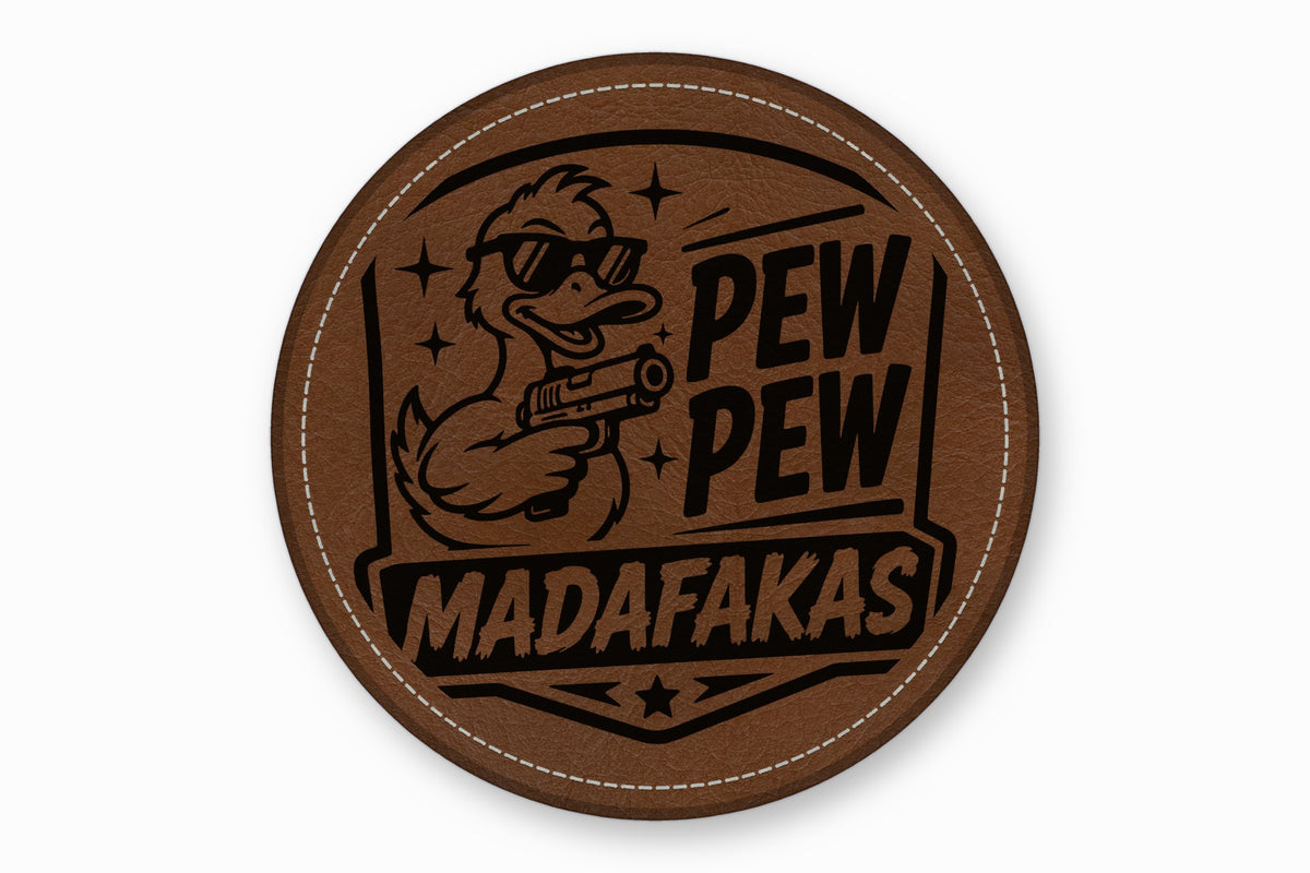 A round brown leather patch features a duck in sunglasses holding a gun, with text reading "PEW PEW MADAFAKAS".