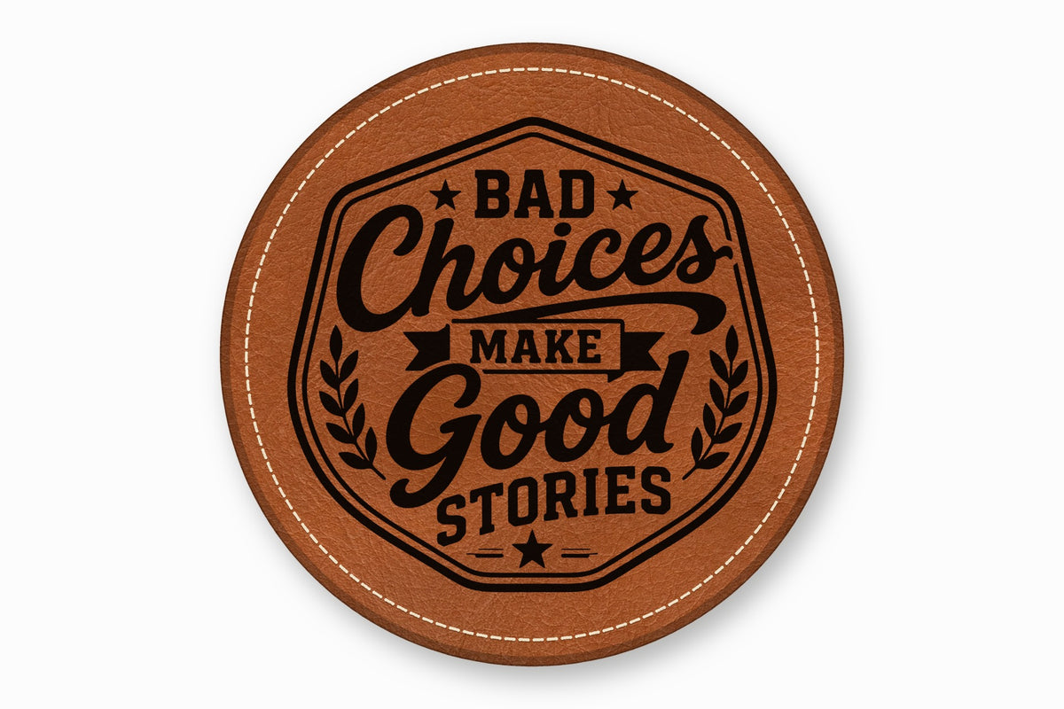 A round brown leather coaster with white stitched edges features the black text Bad Choices Make Good Stories.