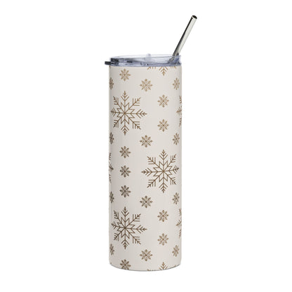 Tall tumbler with a snowflake pattern and a metal straw.