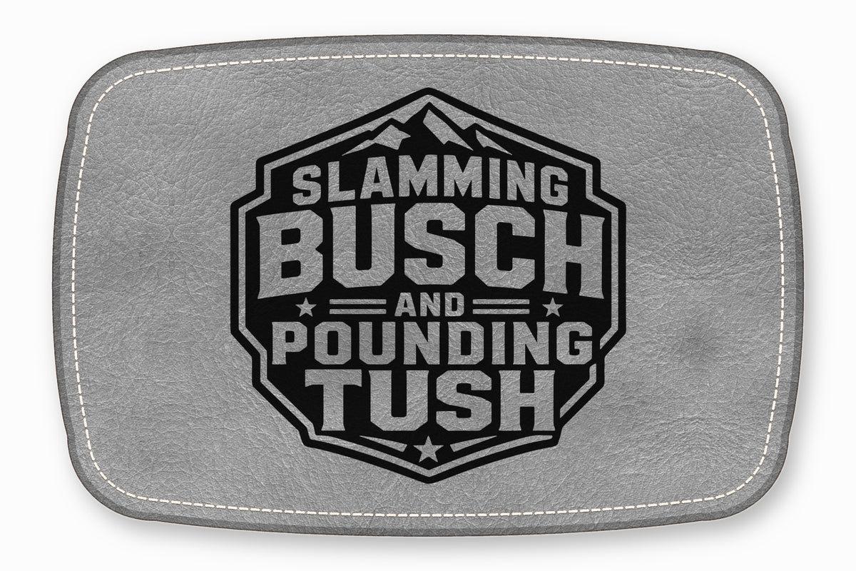 Gray leather patch featuring a black hexagonal emblem with mountains and text reading SLAMMING BUSCH AND POUNDING TUSH.