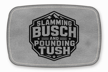 Gray leather patch featuring a black hexagonal emblem with mountains and text reading SLAMMING BUSCH AND POUNDING TUSH.