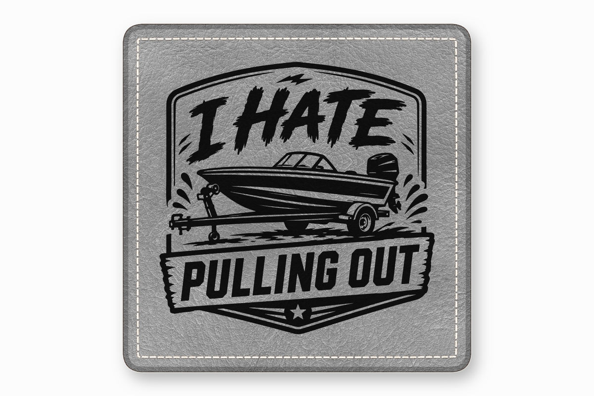Square gray leather patch with white stitched border and a black graphic of a boat on a trailer with text reading I HATE PULLING OUT.