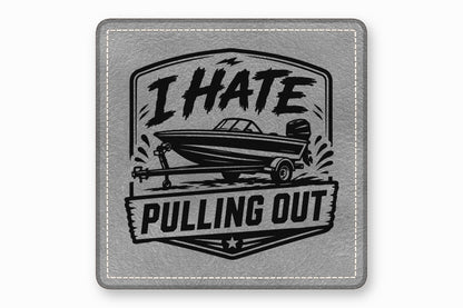 Square gray leather patch with white stitched border and a black graphic of a boat on a trailer with text reading I HATE PULLING OUT.