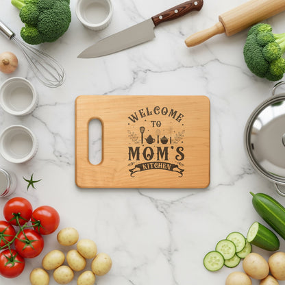 Wooden cutting board with "Welcome to Mom's Kitchen" engraved.