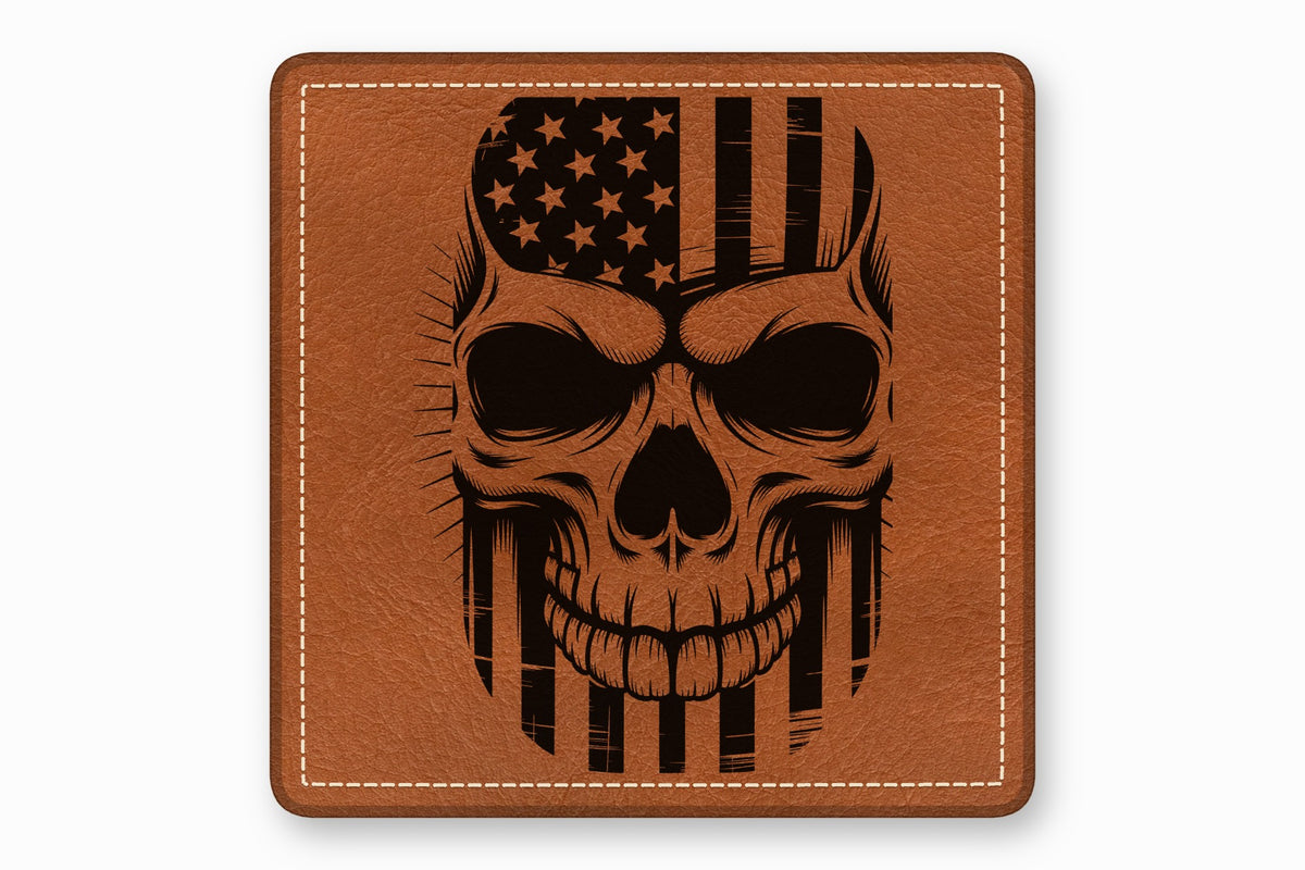 Square brown leather patch with white stitched border featuring a black engraved skull and American flag graphic.