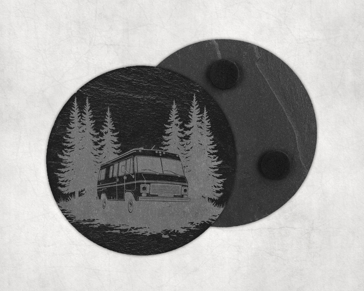 Circular slate coaster with etched forest scene and RV, second coaster behind.
