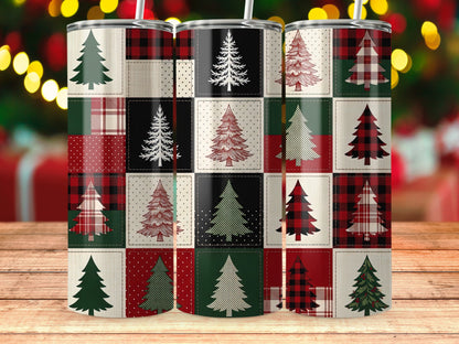 Three tumblers with a patchwork Christmas tree design on a wooden surface.