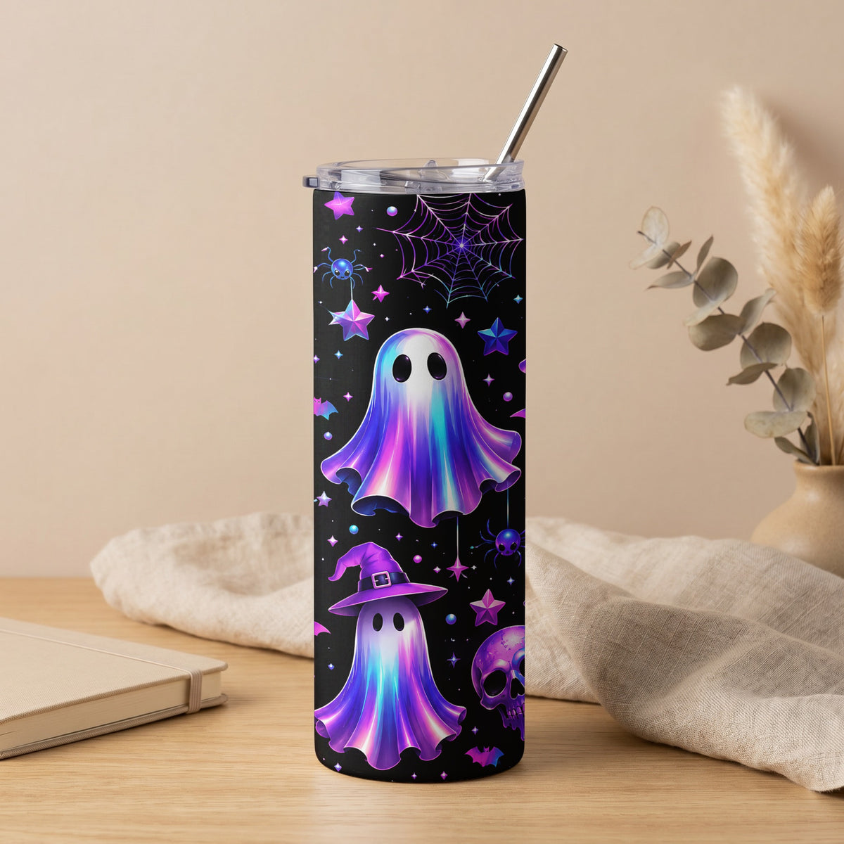 Tumbler with iridescent ghosts, witches hat, skull, spiders, and stars on black.