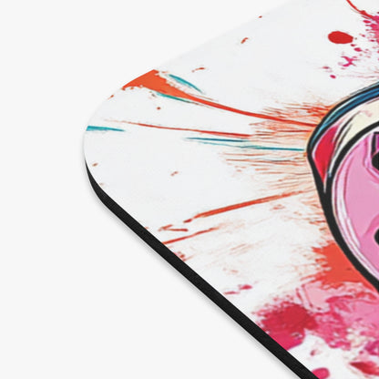 Close-up of a round mousepad with abstract pink, red, and teal paint splatters.