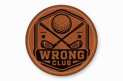 Round brown leather patch with white stitching featuring a black golf emblem and text that reads WRONG CLUB.