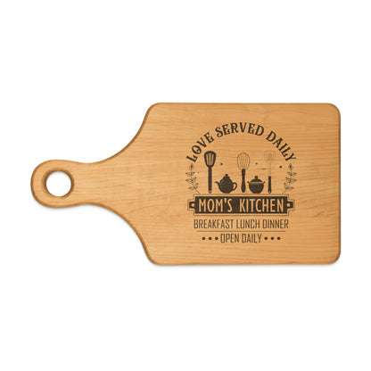Wooden cutting board with "Mom's Kitchen" and kitchen utensils design.