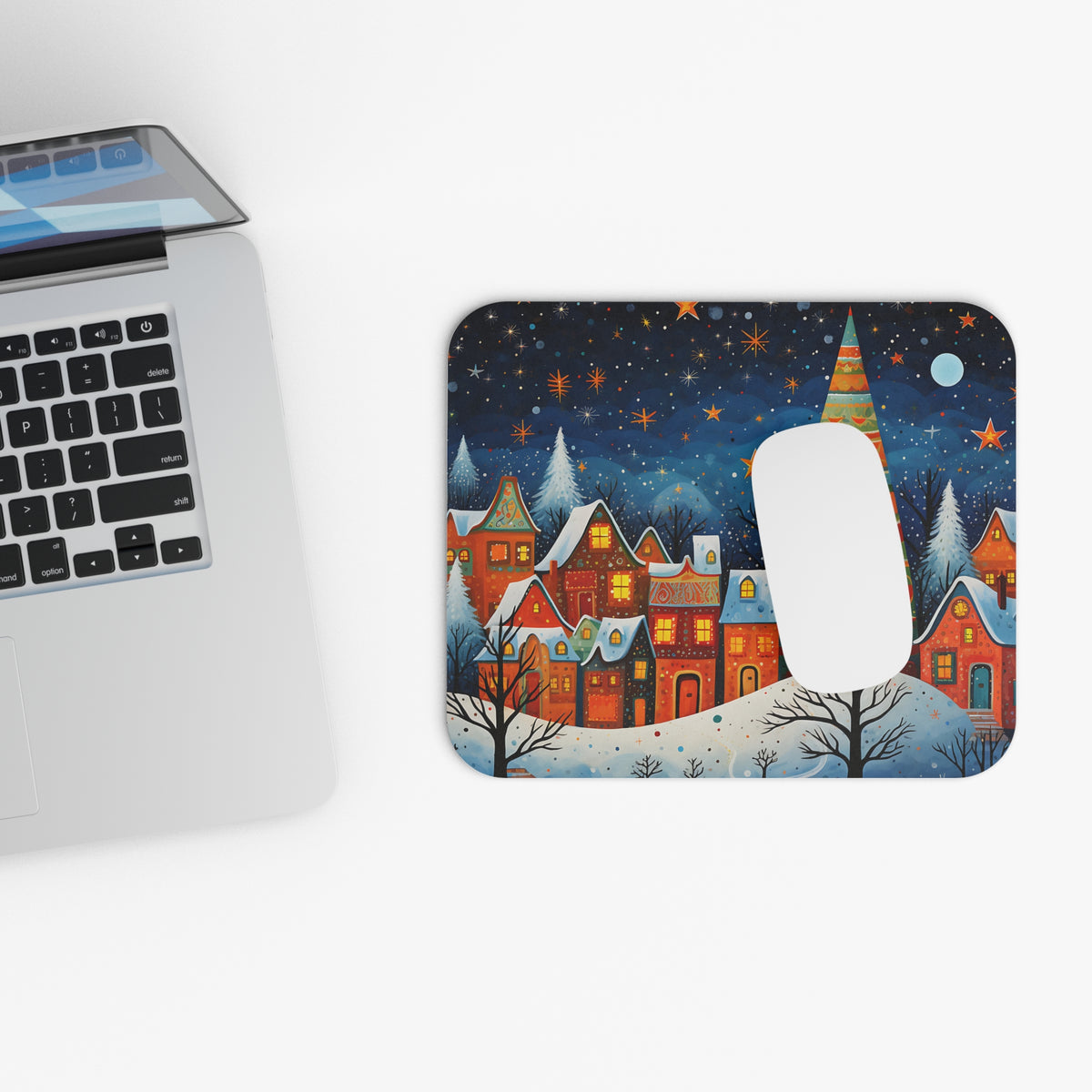 Mousepad with a painted winter village scene under a starry night sky.