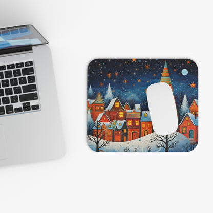 Mousepad with a painted winter village scene under a starry night sky.