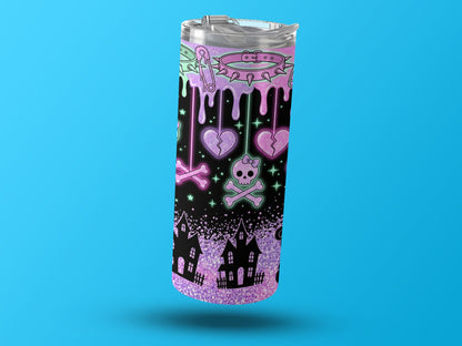 Tumbler with pastel gothic dripping design featuring broken hearts, skulls, and haunted houses.