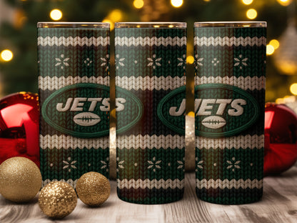 Three New York Jets tumblers with a knitted pattern and Christmas decorations.
