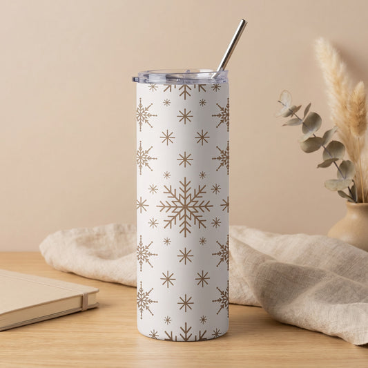 White tumbler with gold snowflake pattern and metal straw.