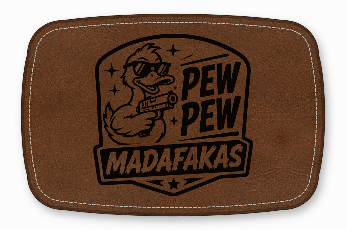 Brown rectangular leather patch with white stitched border and engraved design of a sunglasses-wearing duck holding a gun.