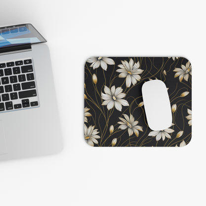 Mousepad with black floral pattern and a white computer mouse.