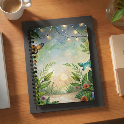Spiral notebook with a watercolor painting of butterflies, flowers, and glowing lights.