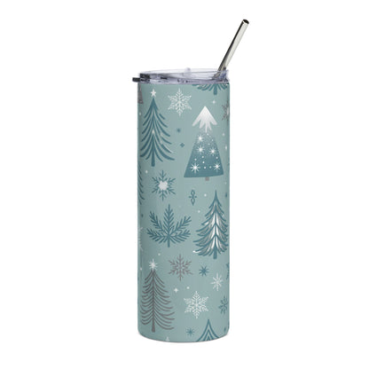 Teal tumbler with a repeating pattern of Christmas trees and snowflakes and a metal straw.