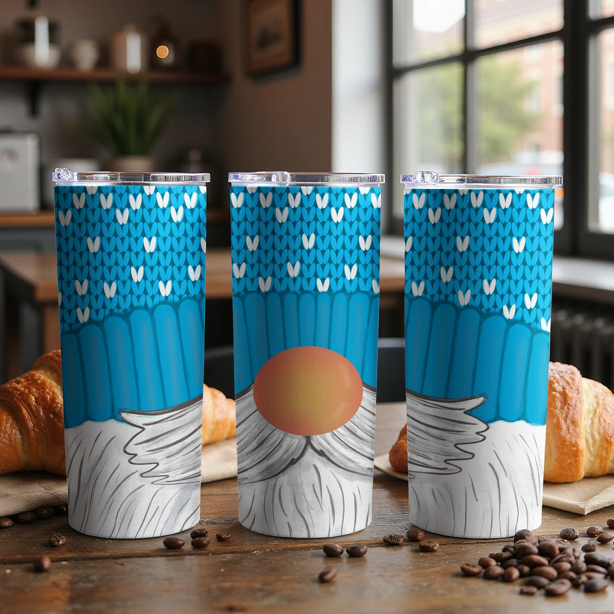 Three tumblers with blue knitted gnome design featuring white hearts and gray beard.