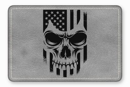 A grey faux-leather rectangular patch featuring a black distressed skull and US flag graphic.
